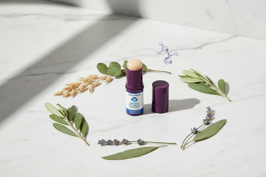 SanusMedi Bakuchiol Anti-Wrinkle Repair Stick surrounded by botanical ingredients on a white marble surface